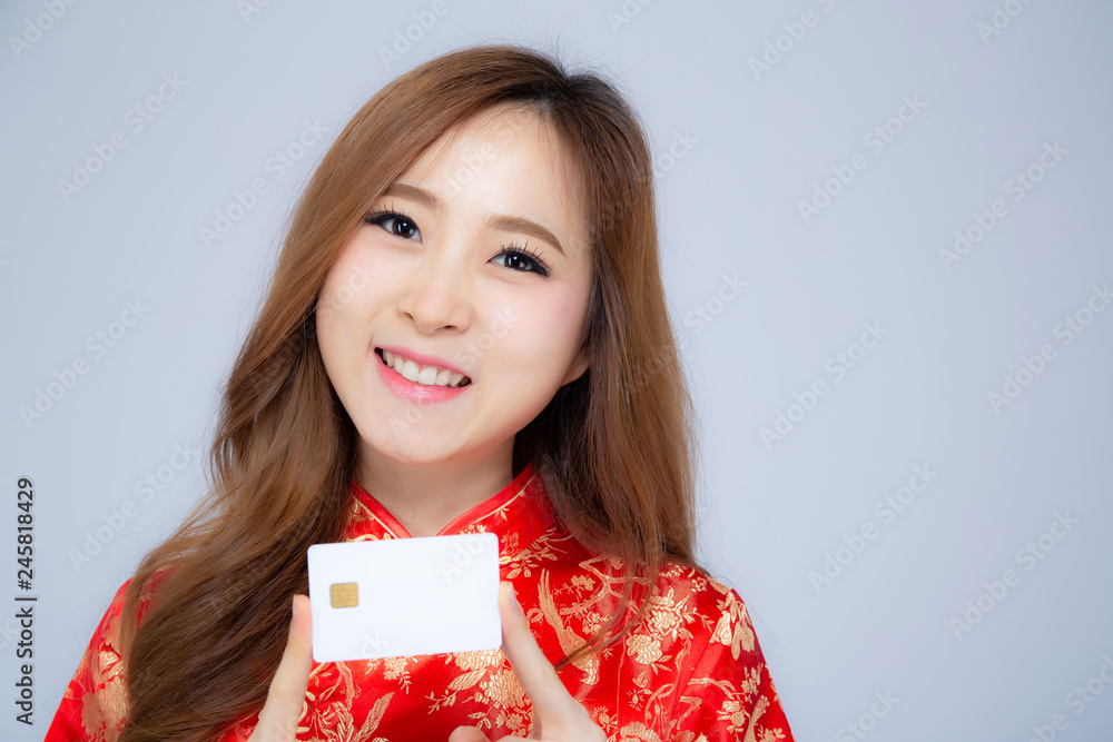 Happy Chinese New Year beautiful portrait young asian woman holding credit card present showing shopping online, girl with purchase for satisfied, holiday concept. Happy Chinese New Year beautiful portrait young asian woman holding credit card present showing shopping online, girl with purchase for satisfied, holiday concept.