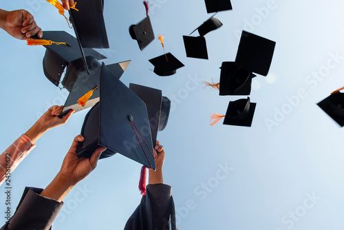 Black hat of the graduates floating in the sky.