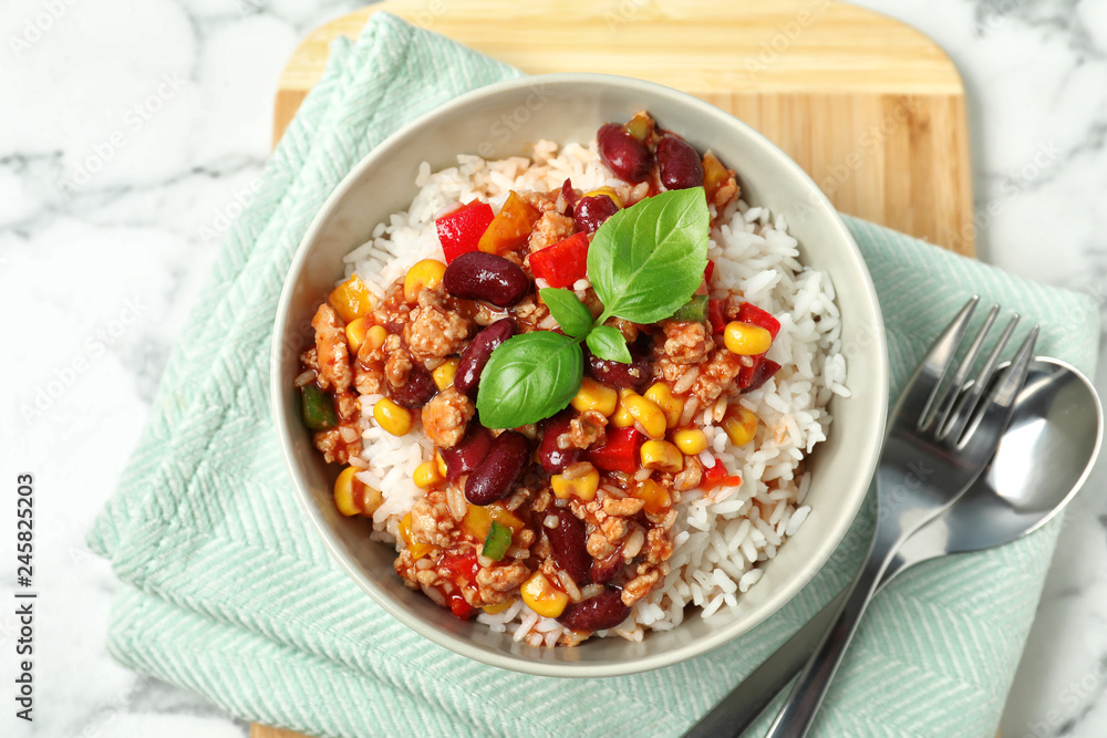 Tasty chili con carne served with rice on marble table, flat lay Tasty chili con carne served with rice on marble table, flat lay