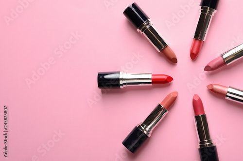 Flat lay composition with lipsticks and space for text on color background