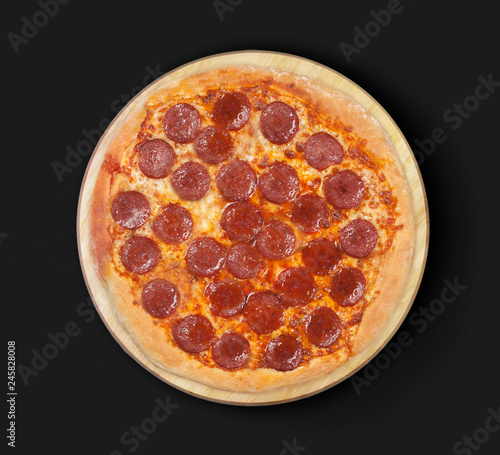 Isolated pizza pepperoni on a black  background.