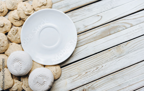 White dish  Meringue  Marshmallow  Zephyr on rustic wooden background. Flat lay. Pastry concept  copy space. Zephyr.