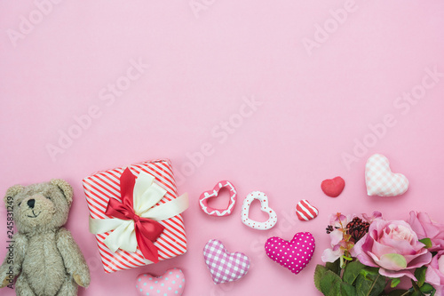 Table top view aerial image of decoration valentine's day background concept.Flat lay cute items.Variety pastel heart shape & gift box present with rose on modern rustic pink paper.copy space for text