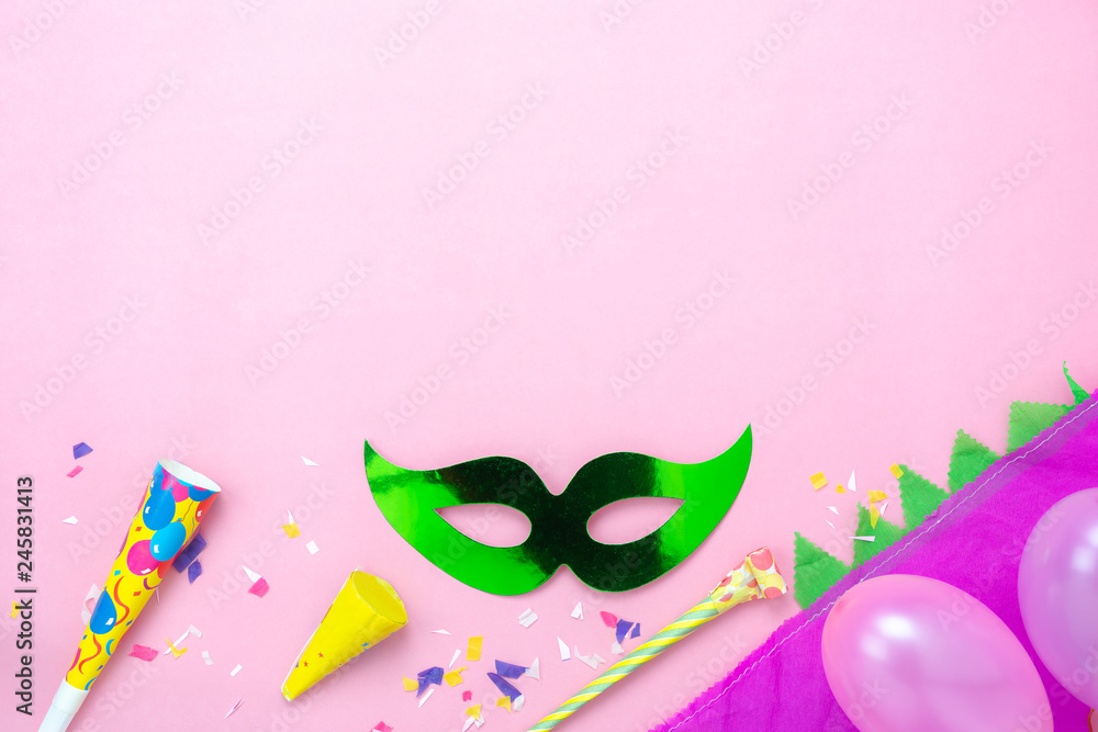 Table top view aerial image of beautiful colorful carnival season or photo booth prop for party background.Flat lay objects colorful mask with hat and balloon on modern pink paper.free space mock up. Table top view aerial image of beautiful colorful carnival season or photo booth prop for party background.Flat lay objects colorful mask with hat and balloon on modern pink paper.free space mock up.