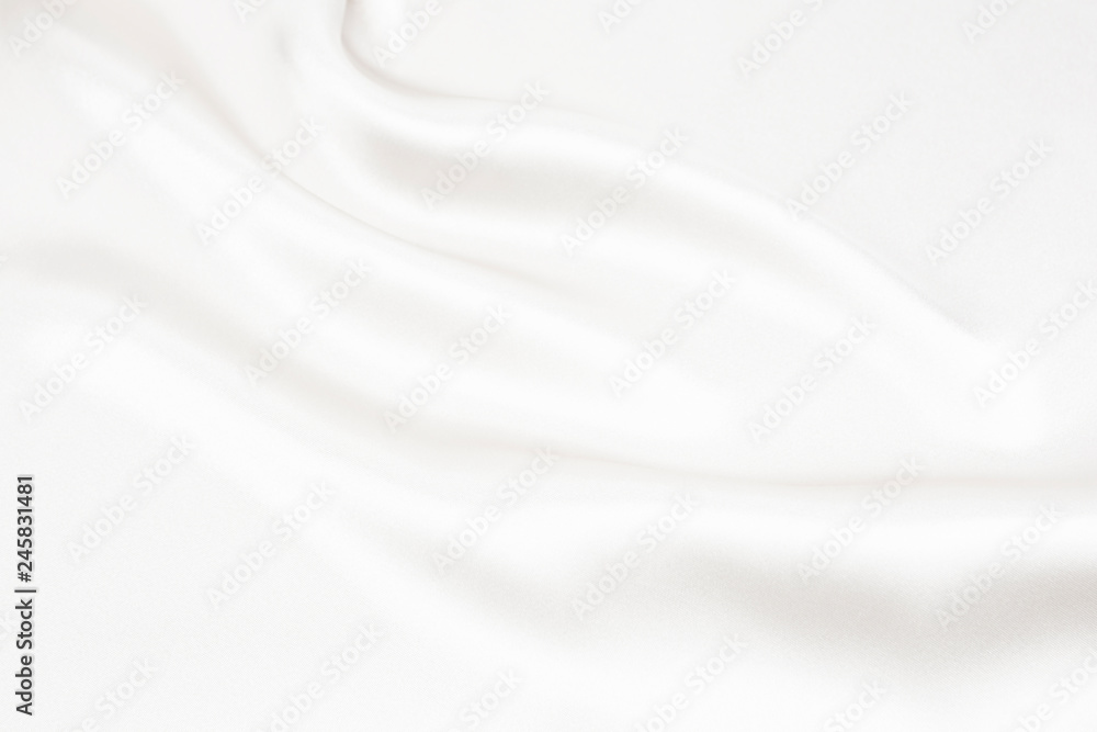 The texture of the satin fabric of white color for the background The texture of the satin fabric of white color for the background