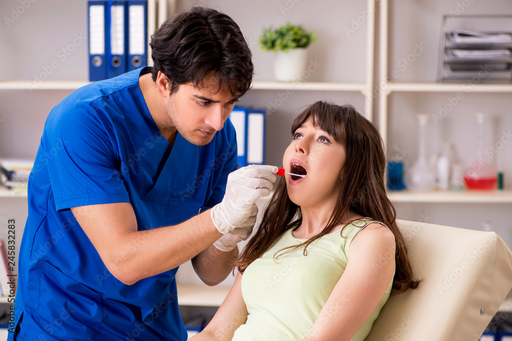 Doctor getting saliva test sample in clinic hospital Doctor getting saliva test sample in clinic hospital