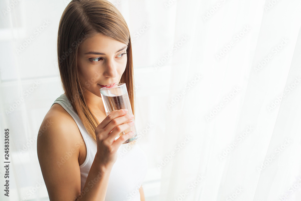 Healthy Lifestyle. Close-up Portrait Of Young Woman Drinking Refreshing Pure Water From Glass. Healthcare. Drinks. Water. Health, Beauty, Diet Concept Healthy Lifestyle. Close-up Portrait Of Young Woman Drinking Refreshing Pure Water From Glass. Healthcare. Drinks. Water. Health, Beauty, Diet Concept