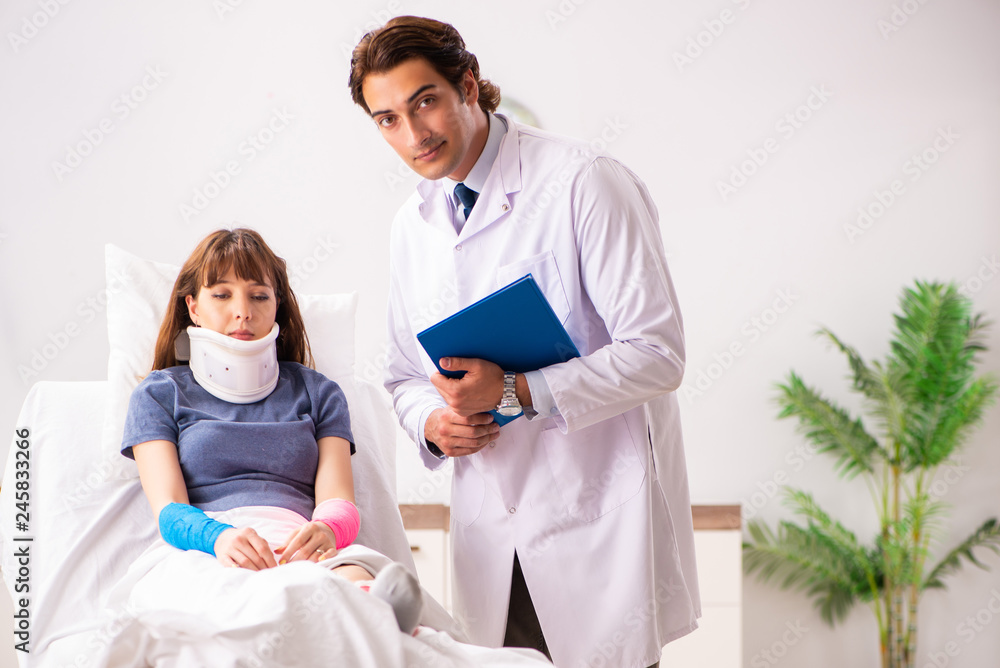 Young doctor examining injured patient Young doctor examining injured patient