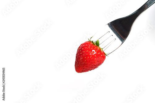Obraz na płótnie healthy Strawberry impale with stanley fork on white isolated background