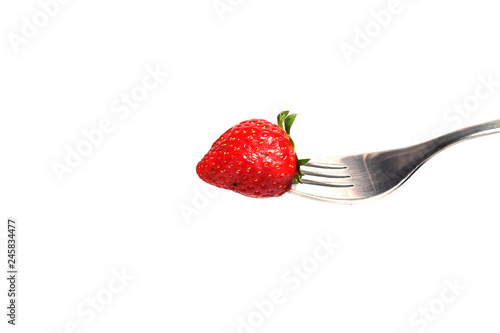 Fotografie healthy Strawberry impale with stanley fork on white isolated background