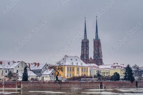 Wrocław covered in snow, a view of the Oder and Ostrów Tumski, winter panorama of Wroclaw with a view of the Odra River and the cathedral