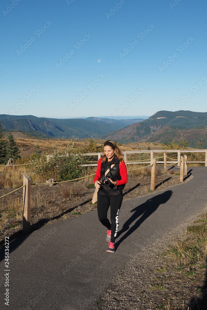 Woman in red fleece hiking the Boundary Trail at Mount Saint Helens National Monument near Johnston Ridge Observatory on a cloudless autumn morning, Woman in red fleece hiking the Boundary Trail at Mount Saint Helens National Monument near Johnston Ridge Observatory on a cloudless autumn morning,
