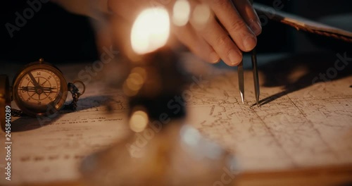 Different views of a vintage 1850 mapmaker using a compass divider going over a map taking notes