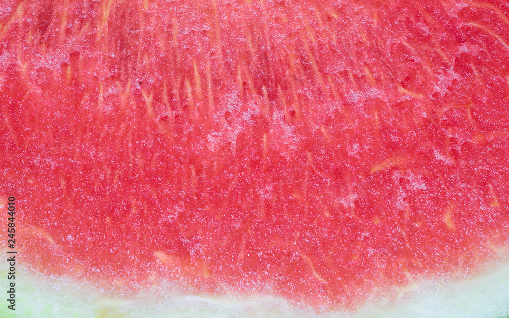 closeup of a fresh slice of red watermelon textured background.