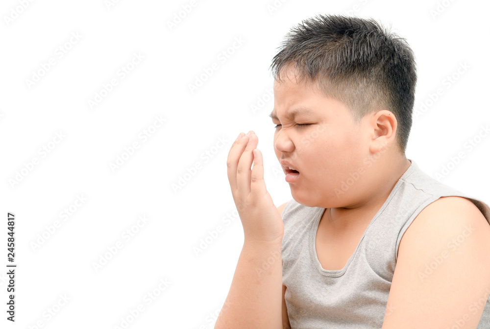 Obese fat boy checking his breath with his hand isolated Obese fat boy checking his breath with his hand isolated