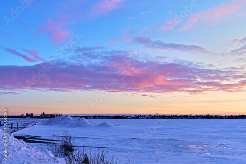 Beautiful pink sunset over frozen ice and snow