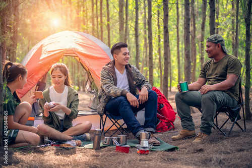 Young asian people hiking in the forest during summer at sunset,travel,tourism and teamwork concept