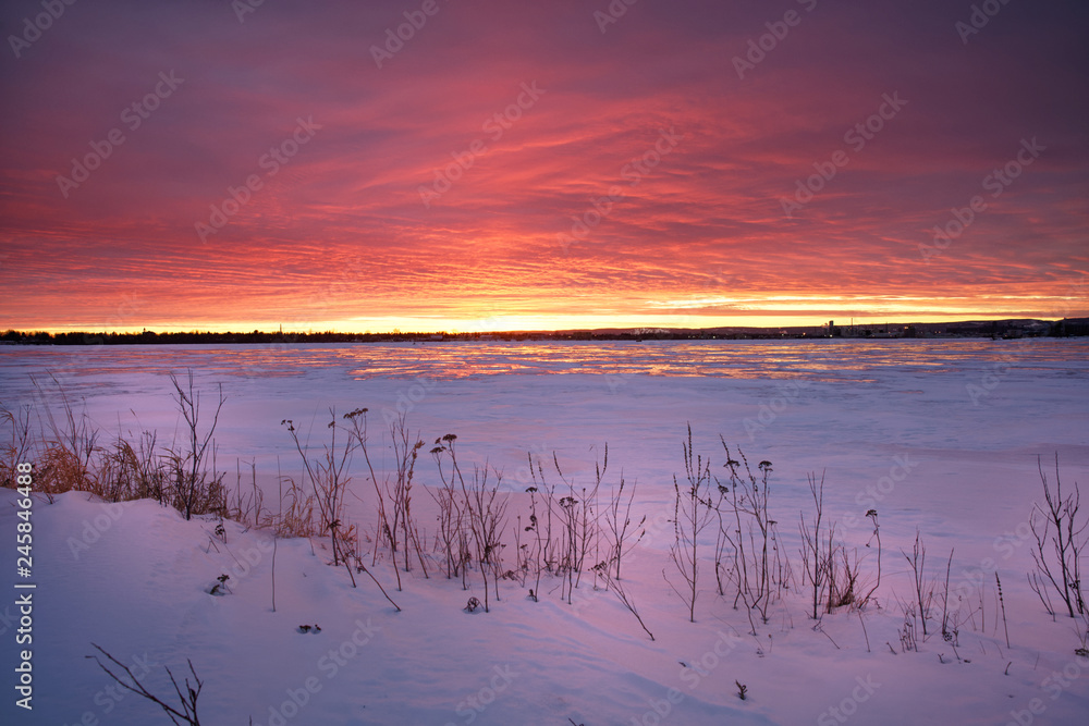 Pink and orange sunset over ice and snow horizon