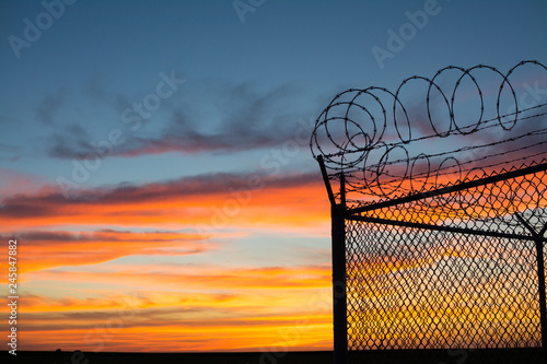 BSilouette of fence at sunset photo