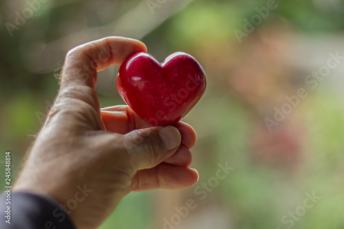 man holding a heart in his hand 