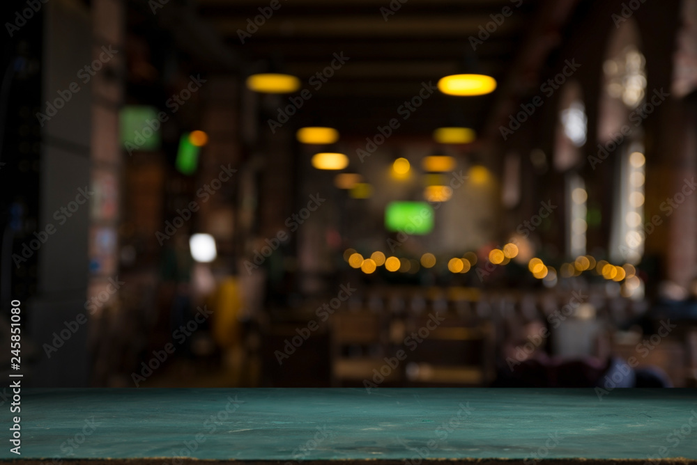 image of wooden table in front of abstract blurred background of resturant lights image of wooden table in front of abstract blurred background of resturant lights