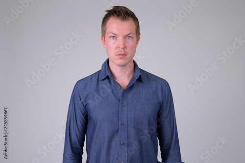 Portrait of young handsome businessman looking at camera © Ranta Images