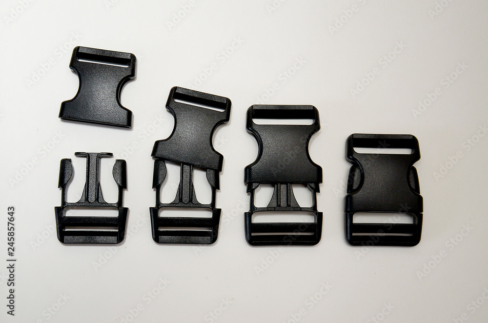 three-point black fastex lies on a white background three-point black fastex lies on a white background