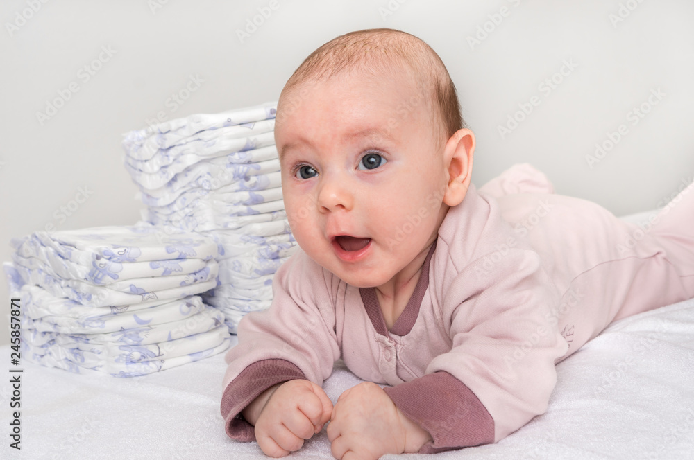 Stack of diapers or nappies with newborn baby Stack of diapers or nappies with newborn baby