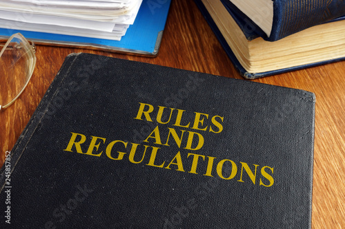 Tablou pe pânză Rules and regulations book on the desk.