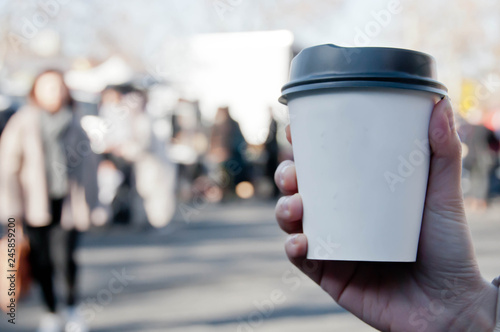 Wallpaper Mural Take away white paper hot coffee cup with right hand holding in Sunday flea market Torontodigital.ca