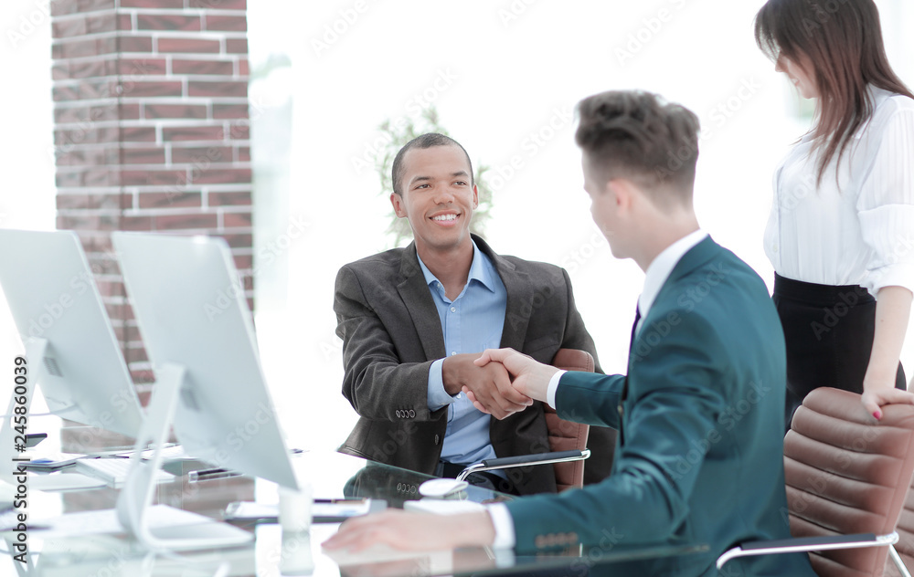 handshake business people behind a Desk in the office