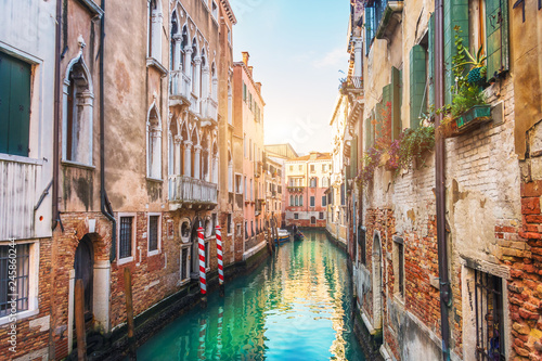 Narrow streets with canals and apartment buildings in Venice, Italy.