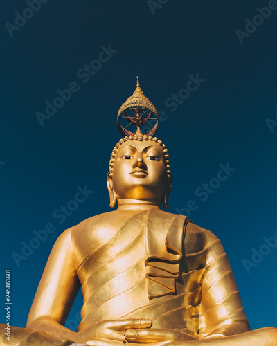 Wat Tham Seua or Tiger Cave Temple mountain top golden Buddha statue