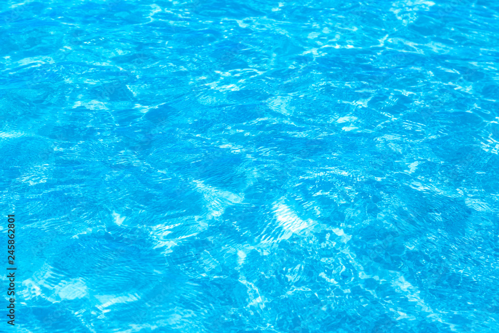 Surface of blue clear swimming pool. Water background pattern for background.