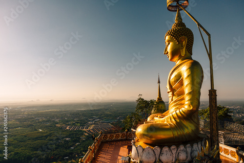 Big gold Buddha statue at the sunrise in Tiger Cave Temple in Krabi province  Thailand