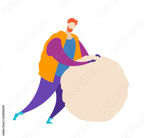 A guy dressed in outerwear makes a big snowball for a snowman.