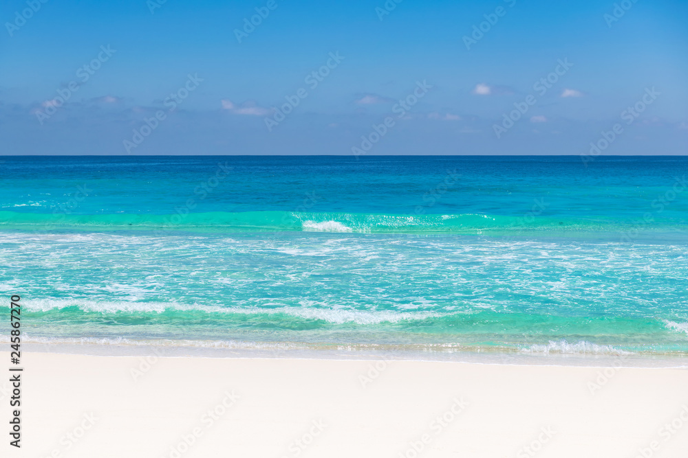Beautiful sandy beach with turquoise sea. Tropical beach background.