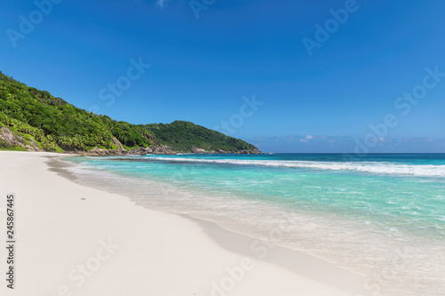 Sandy beach with turquoise sea. Tropical beach background.