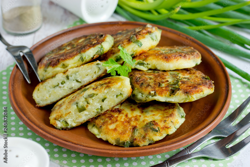 Cottage cheese pancakes or syrniki with herbs green onion and parsley