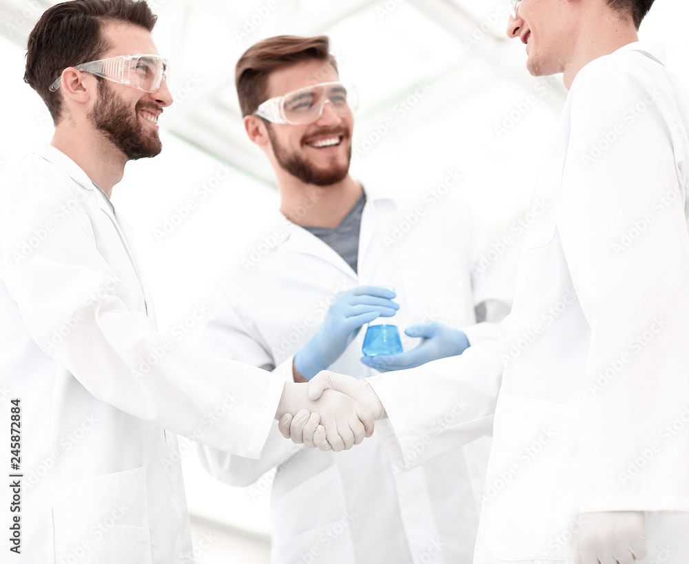 blurred image of a handshake between scientists blurred image of a handshake between scientists