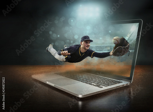 Baseball players in dynamic action professional sport game play on the laptop in under stadium lights.