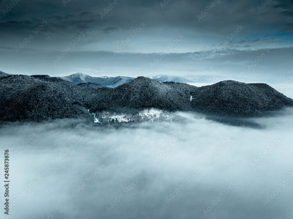Epic foggy winter wallpaper,with dark clouds,captured with drone