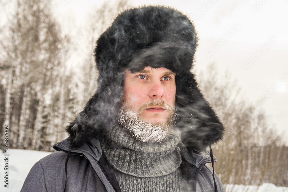 frozen man with a beard in winter in a forest with snowdrifts fell ill from the cold after a walk in the village frozen man with a beard in winter in a forest with snowdrifts fell ill from the cold after a walk in the village