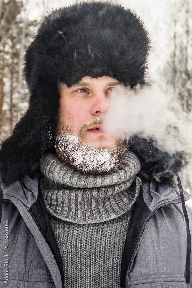 frozen man with a beard in winter in a forest with snowdrifts fell ill from the cold after a walk in the village frozen man with a beard in winter in a forest with snowdrifts fell ill from the cold after a walk in the village