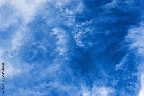 A configuration of cirrostratus clouds set on bright blue sky.