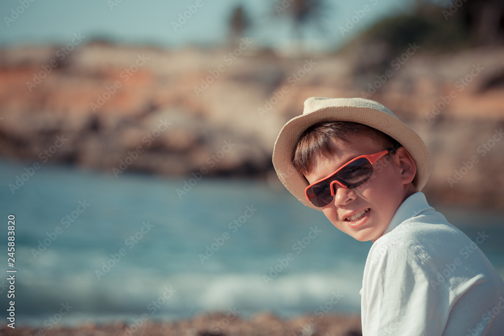 Portrait of teenager sitting near sea, outdoor