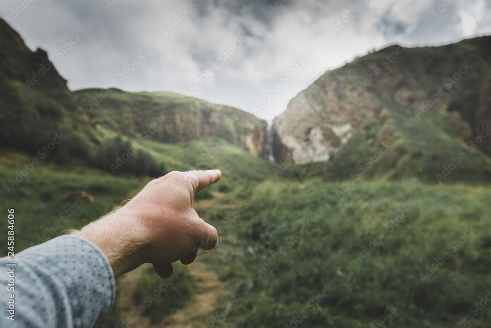 Male hand indicates the direction of movement, point of view shot. Travel Adventure Journey Concept Male hand indicates the direction of movement, point of view shot. Travel Adventure Journey Concept