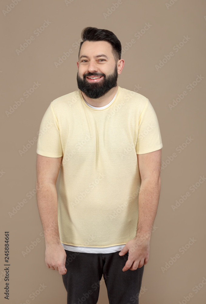 cute brunette with beard in yellow t-shirt smiling cute brunette with beard in yellow t-shirt smiling
