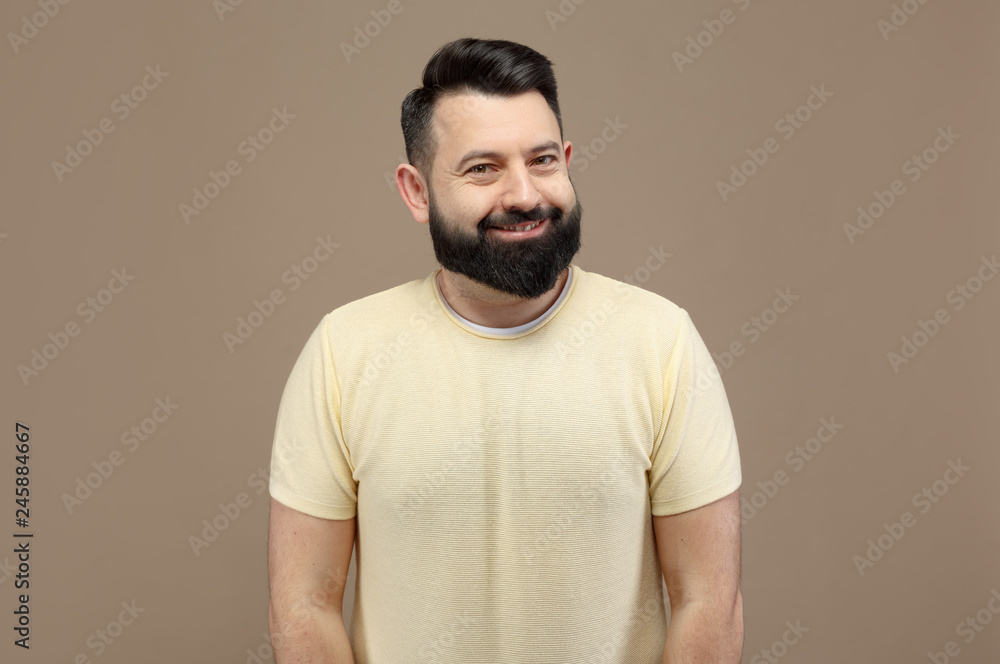 cute brunette with beard in yellow t-shirt smiling cute brunette with beard in yellow t-shirt smiling