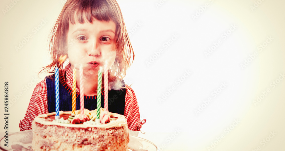 Beautiful adorable five year old girl celebrating her birthday, blowing candles on homemade baked cake. Holiday, happy childhood and birthday concept. Beautiful adorable five year old girl celebrating her birthday, blowing candles on homemade baked cake. Holiday, happy childhood and birthday concept.